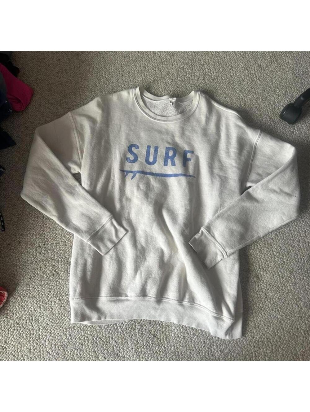 Oat Collective cream & white sweatshirt with blue 'SURF' graphic